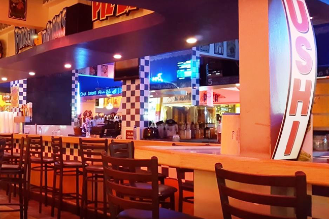 Cozy diner interior with checkered tiles, wooden chairs, and ambient lighting. Counters and retro decor create a nostalgic, welcoming atmosphere.