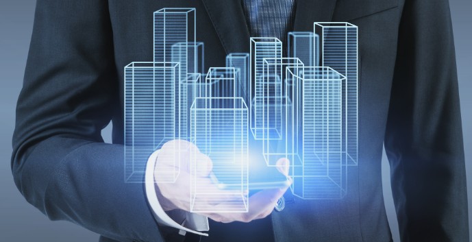 A businessman holds a smartphone, projecting a digital hologram of skyscrapers. The scene is futuristic and tech-focused, with a blue glow conveying innovation.